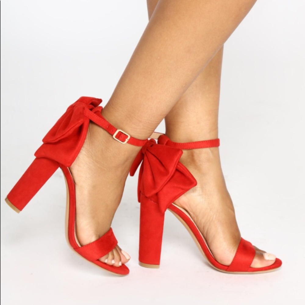Unworn red heels with a red bow